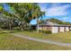 Well maintained property featuring mature trees, green grass, and tranquil pond views at 4463 Atwood Cay Pl # 22, Sarasota, FL 34233
