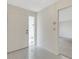 Clean, tiled foyer featuring a white front door and an open view into another room at 4463 Atwood Cay Pl # 22, Sarasota, FL 34233