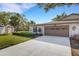Charming home featuring a well-manicured lawn, mature trees, and a two-car garage at 4463 Atwood Cay Pl # 22, Sarasota, FL 34233