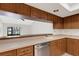 Kitchen featuring wood cabinets, stainless steel dishwasher and light countertops at 4463 Atwood Cay Pl # 22, Sarasota, FL 34233