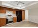 Kitchen featuring stainless steel appliances, wooden cabinetry, and light wood flooring at 4463 Atwood Cay Pl # 22, Sarasota, FL 34233