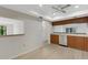 Kitchen featuring wood cabinets, laminate countertop, stainless steel dishwasher, and wood floor at 4463 Atwood Cay Pl # 22, Sarasota, FL 34233