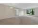 Bright living room with neutral carpet, a chandelier, and a large window at 4463 Atwood Cay Pl # 22, Sarasota, FL 34233