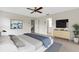 Modern, furnished main bedroom featuring tile flooring, ceiling fan, and ensuite bathroom access at 4463 Atwood Cay Pl # 22, Sarasota, FL 34233