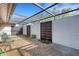 Spacious patio with a transparent awning providing sunlight and beautiful outdoor plants at 4463 Atwood Cay Pl # 22, Sarasota, FL 34233