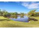 Scenic pond view with lush greenery and mature trees creating a serene setting at 4463 Atwood Cay Pl # 22, Sarasota, FL 34233