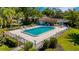 Aerial view of a community pool area with ample seating and a screened enclosure at 4463 Atwood Cay Pl # 22, Sarasota, FL 34233