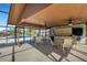 Screened pavilion at the community pool with tables, chairs, ceiling fans, and kitchen area at 4463 Atwood Cay Pl # 22, Sarasota, FL 34233