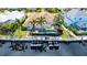 Aerial view showcasing the backyard with a screened pool, lush landscaping, and waterfront access at 4741 Pinnacle Dr, Bradenton, FL 34208