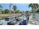 View of a private boat lift on the water with palm trees and houses in the background at 4741 Pinnacle Dr, Bradenton, FL 34208