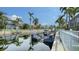 A boat lift in a canal with palm trees and houses visible in the distance at 4741 Pinnacle Dr, Bradenton, FL 34208