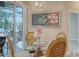 Dining area features a glass table, ornate chairs, and view to the pool patio area through sliding glass doors at 4741 Pinnacle Dr, Bradenton, FL 34208