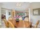Well lit dining area features views to the kitchen and an ornate wooden table with carved legs at 4741 Pinnacle Dr, Bradenton, FL 34208
