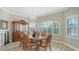 Dining room featuring a wooden table, decorative cabinet, chandelier, and views to the outside at 4741 Pinnacle Dr, Bradenton, FL 34208
