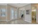 Bright foyer with double french doors leading to a home office and a hallway to a powder room at 4741 Pinnacle Dr, Bradenton, FL 34208