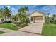 Welcoming front exterior with a manicured lawn, paver driveway, and carport at 4741 Pinnacle Dr, Bradenton, FL 34208