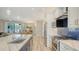 Long kitchen island featuring white marble countertop and stainless steel appliances in an open layout at 4741 Pinnacle Dr, Bradenton, FL 34208