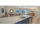 Kitchen island with white marble countertop and navy blue cabinets in an open floor plan at 4741 Pinnacle Dr, Bradenton, FL 34208