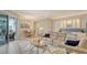 Open-concept living area featuring a large sofa, dining table, and seamless access to an outdoor lanai at 4741 Pinnacle Dr, Bradenton, FL 34208