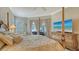 Bedroom featuring a four-poster bed, decorative furniture, and view to the outside pool and patio area at 4741 Pinnacle Dr, Bradenton, FL 34208