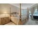 Bright bedroom with a four-poster bed, decorative furniture, and view to the outside pool and patio area at 4741 Pinnacle Dr, Bradenton, FL 34208