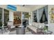 Relaxing covered patio with cozy seating and a view through the sliding doors at 4741 Pinnacle Dr, Bradenton, FL 34208