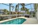 Relaxing enclosed pool with tropical landscaping and scenic water views at 4741 Pinnacle Dr, Bradenton, FL 34208