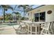 Inviting pool area with shade, a built-in bar, and an outdoor dining area at 4741 Pinnacle Dr, Bradenton, FL 34208