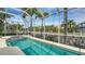 Inviting pool with an attached spa and tropical landscaping, all within a screened enclosure at 4741 Pinnacle Dr, Bradenton, FL 34208