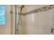 Tiled shower featuring mosaic accents, bronze shower head and decorative glass on door at 4741 Pinnacle Dr, Bradenton, FL 34208