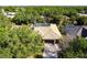 Aerial view showcasing a tile-roofed home, lush greenery, and a screened-in pool, creating a serene backyard oasis at 4915 Old Tree Pl, Sarasota, FL 34233