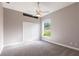 Neutral bedroom with a ceiling fan, a window with view, and a double closet at 4915 Old Tree Pl, Sarasota, FL 34233