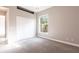 This carpeted bedroom has a window for natural light and a closet for storage at 4915 Old Tree Pl, Sarasota, FL 34233