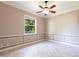 This bright bedroom has decorative molding, a ceiling fan, and tile flooring at 4915 Old Tree Pl, Sarasota, FL 34233
