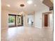 Bright dining room features elegant chandelier and large sliding glass doors leading to screened lanai and pool at 4915 Old Tree Pl, Sarasota, FL 34233