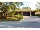 Charming single-story home with a well-manicured lawn, mature landscaping, and a two-car garage at 4915 Old Tree Pl, Sarasota, FL 34233