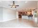 Spacious living area leading to a modern kitchen with breakfast bar and stainless steel appliances at 4915 Old Tree Pl, Sarasota, FL 34233