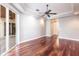 Large living room featuring wood flooring, neutral walls and a sliding glass door to a patio seating area at 4915 Old Tree Pl, Sarasota, FL 34233