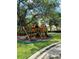 A fun backyard playground features a wooden playset for children to enjoy, fostering an active lifestyle at 4915 Old Tree Pl, Sarasota, FL 34233