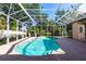 Backyard screened pool with brick patio complemented by lush landscaping providing the perfect outdoor retreat at 4915 Old Tree Pl, Sarasota, FL 34233