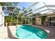 A sparkling pool in a screened enclosure, surrounded by lush landscaping at 4915 Old Tree Pl, Sarasota, FL 34233