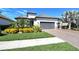 Single-story home with gray tile roof, gray garage doors, and well-manicured landscaping at 5376 Trails Bend Ct, Sarasota, FL 34238