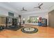 Spacious gym with hardwood floors and ceiling fans also features exercise equipment and a rack of workout balls at 5376 Trails Bend Ct, Sarasota, FL 34238
