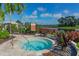 Inviting community hot tub with lush tropical landscaping with serene view of the community lake at 5376 Trails Bend Ct, Sarasota, FL 34238