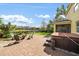 Backyard patio with hot tub and seating area overlooking the lake and neighborhood at 5522 Cartagena Dr, Sarasota, FL 34233