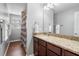 Bathroom featuring a granite vanity, mirror, and shower/tub combo with dark brown cabinetry at 5522 Cartagena Dr, Sarasota, FL 34233