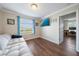 This bedroom features a sofa, wood floors, and a view of the outdoors at 5522 Cartagena Dr, Sarasota, FL 34233