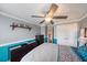 Bedroom with a ceiling fan, crown molding, dressers, and closet doors at 5522 Cartagena Dr, Sarasota, FL 34233