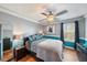 This bedroom features wood floors, a ceiling fan, and a dark colored wall at 5522 Cartagena Dr, Sarasota, FL 34233