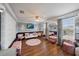 A large bonus room featuring wood flooring, a tv, a mirror, and other furniture at 5522 Cartagena Dr, Sarasota, FL 34233